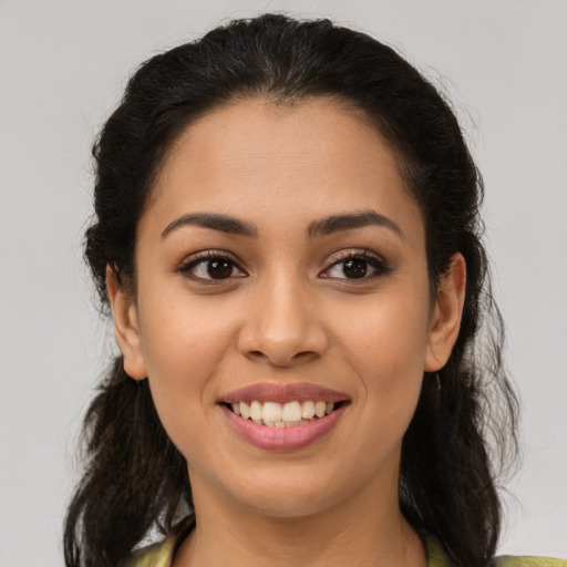 Joyful latino young-adult female with medium  brown hair and brown eyes