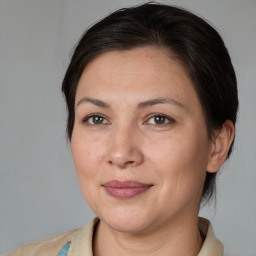 Joyful white adult female with medium  brown hair and brown eyes