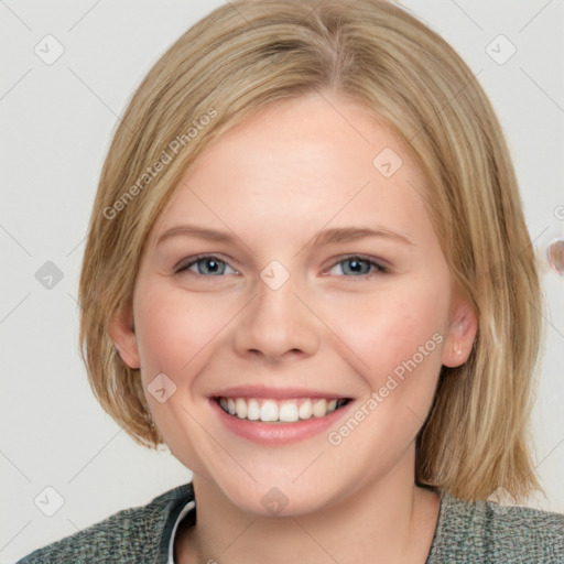 Joyful white young-adult female with medium  brown hair and blue eyes