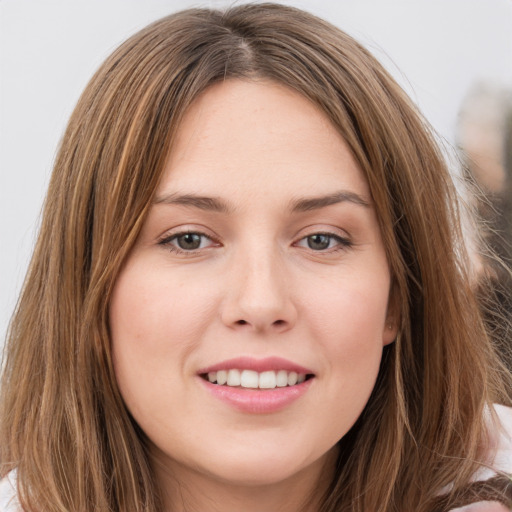 Joyful white young-adult female with long  brown hair and green eyes