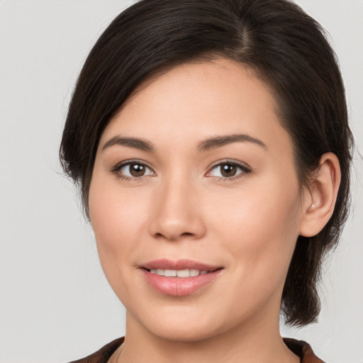 Joyful white young-adult female with medium  brown hair and brown eyes