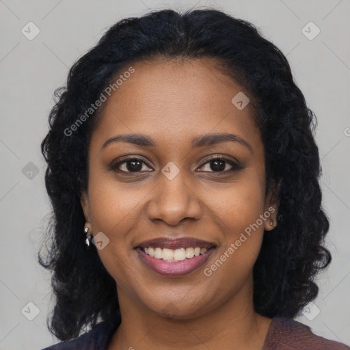 Joyful black young-adult female with long  black hair and brown eyes