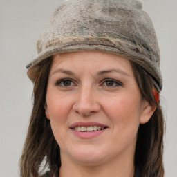 Joyful white adult female with medium  brown hair and grey eyes