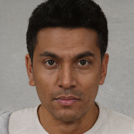 Neutral latino young-adult male with short  black hair and brown eyes