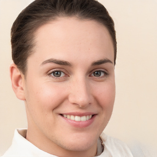 Joyful white young-adult female with short  brown hair and brown eyes