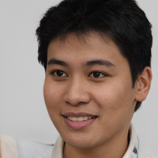 Joyful asian young-adult male with short  brown hair and brown eyes