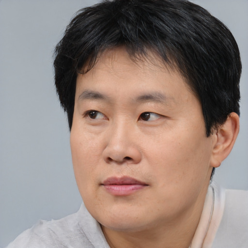 Neutral asian young-adult male with short  brown hair and brown eyes