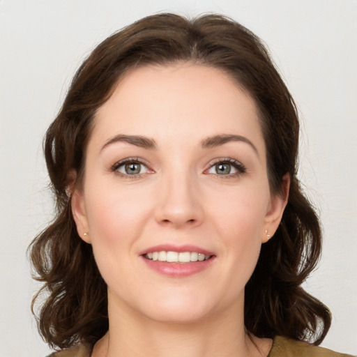 Joyful white young-adult female with medium  brown hair and green eyes