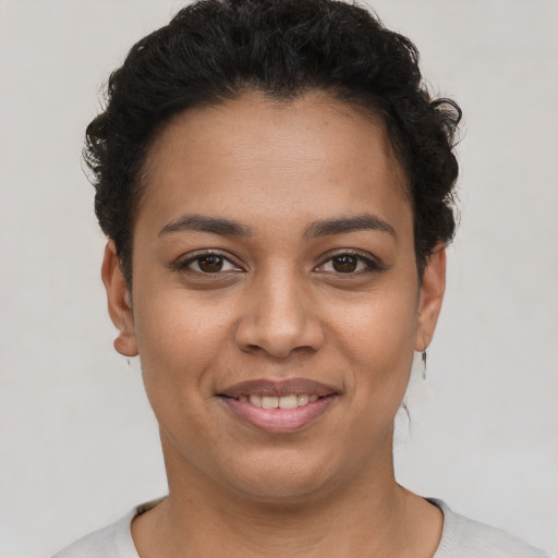 Joyful latino young-adult female with short  brown hair and brown eyes