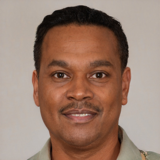 Joyful latino adult male with short  black hair and brown eyes