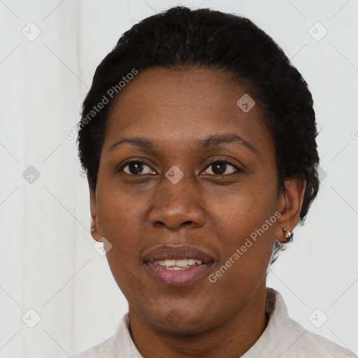 Joyful black adult female with short  black hair and brown eyes