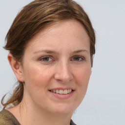 Joyful white young-adult female with medium  brown hair and blue eyes