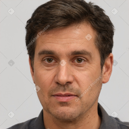 Joyful white adult male with short  brown hair and brown eyes