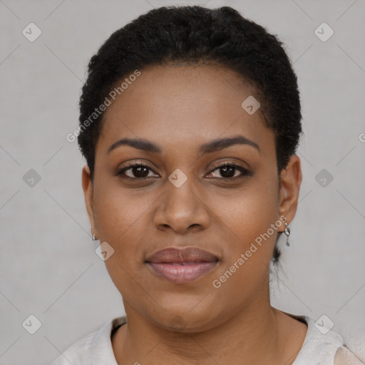 Joyful black young-adult female with short  black hair and brown eyes