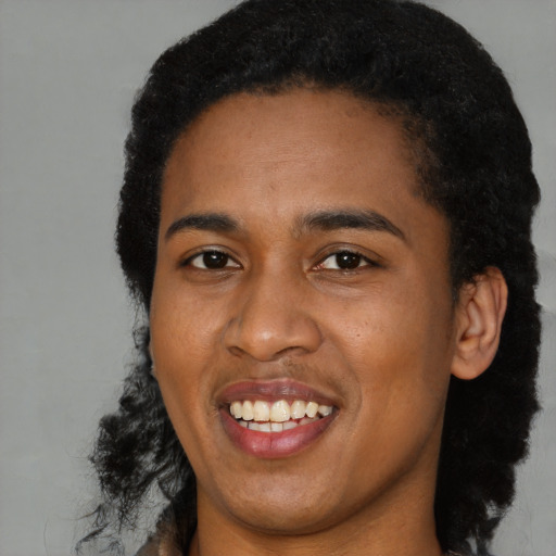 Joyful black young-adult female with short  black hair and brown eyes