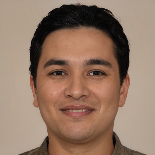 Joyful latino young-adult male with short  black hair and brown eyes