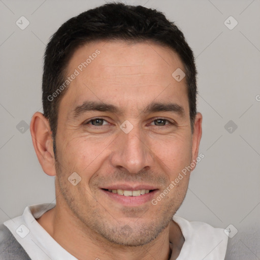 Joyful white adult male with short  brown hair and brown eyes