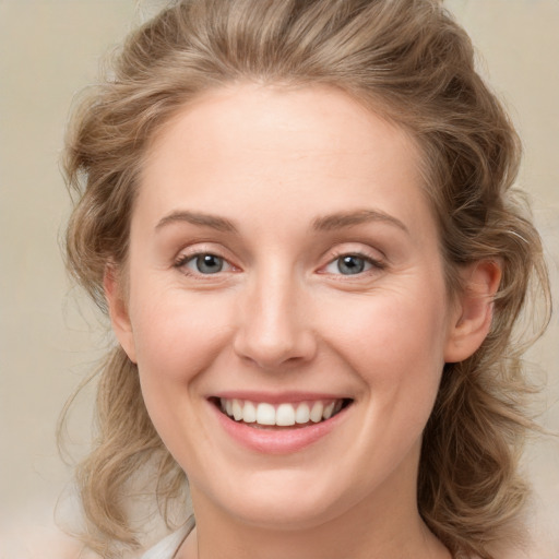 Joyful white young-adult female with medium  brown hair and green eyes