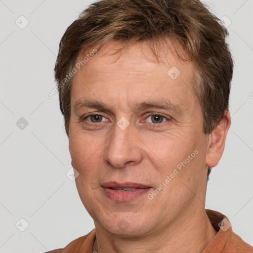 Joyful white adult male with short  brown hair and brown eyes