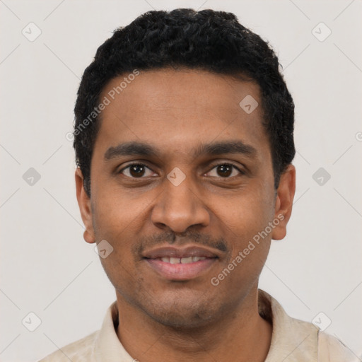 Joyful black young-adult male with short  black hair and brown eyes