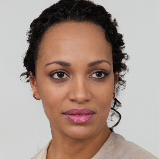 Joyful black young-adult female with short  brown hair and brown eyes