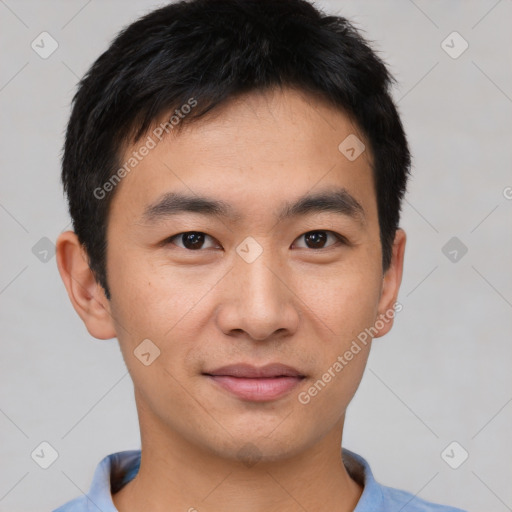 Joyful asian young-adult male with short  black hair and brown eyes