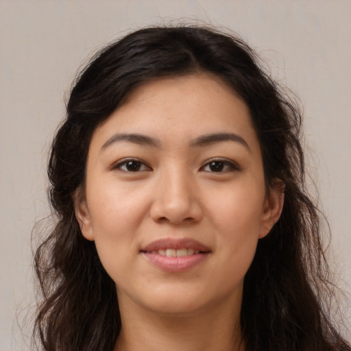 Joyful latino young-adult female with long  brown hair and brown eyes