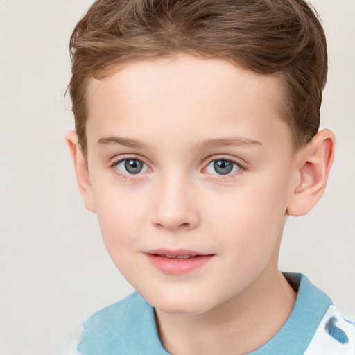 Joyful white child male with short  brown hair and grey eyes