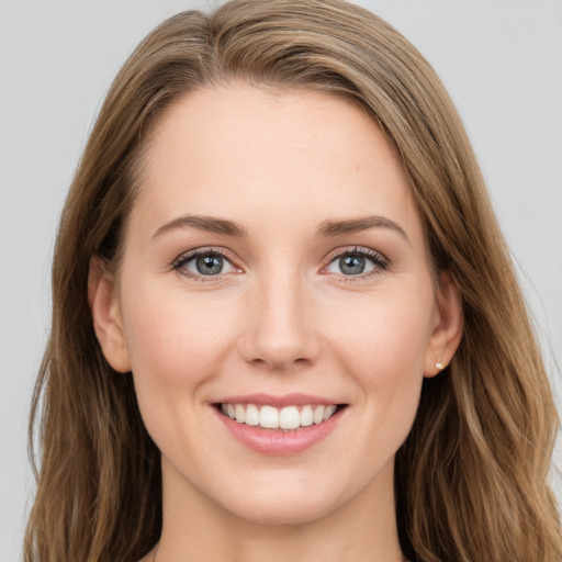 Joyful white young-adult female with long  brown hair and green eyes