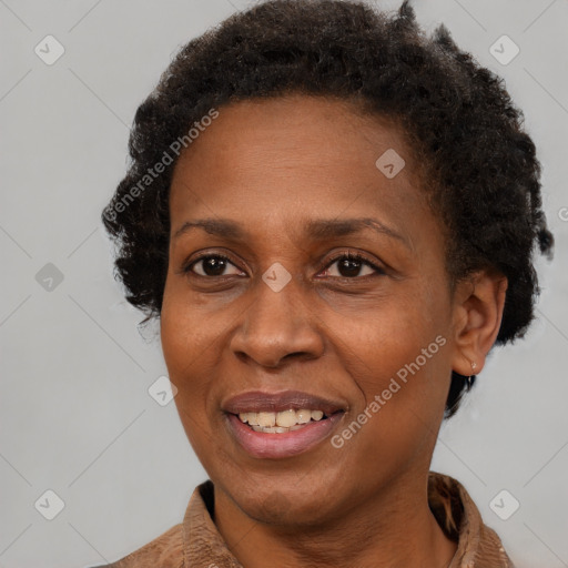 Joyful black adult female with short  brown hair and brown eyes