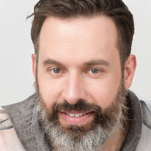 Joyful white adult male with short  brown hair and grey eyes