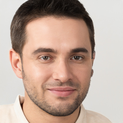 Joyful white young-adult male with short  brown hair and brown eyes