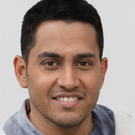 Joyful asian young-adult male with short  brown hair and brown eyes