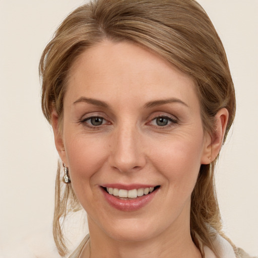 Joyful white young-adult female with long  brown hair and grey eyes