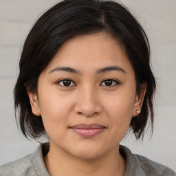 Joyful white young-adult female with medium  brown hair and brown eyes