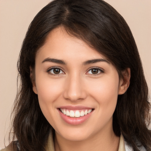 Joyful white young-adult female with long  brown hair and brown eyes