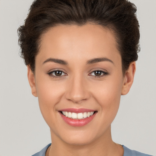 Joyful white young-adult female with short  brown hair and brown eyes