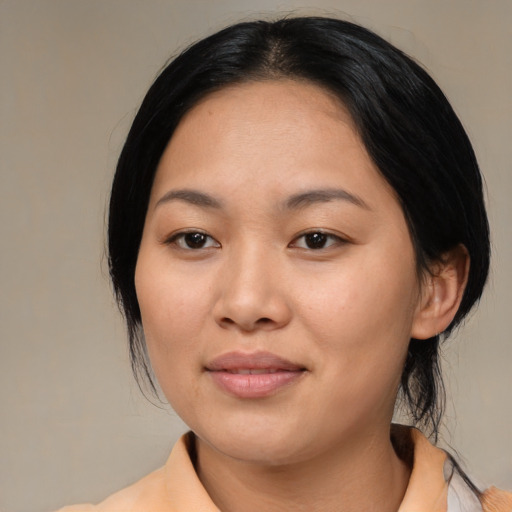 Joyful asian young-adult female with medium  black hair and brown eyes