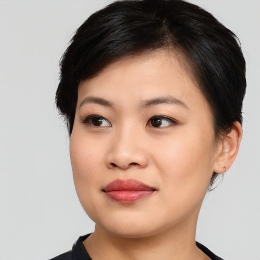 Joyful asian young-adult female with medium  black hair and brown eyes