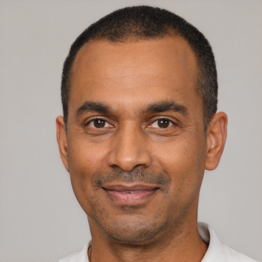 Joyful latino adult male with short  black hair and brown eyes