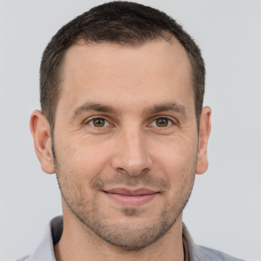 Joyful white young-adult male with short  brown hair and brown eyes