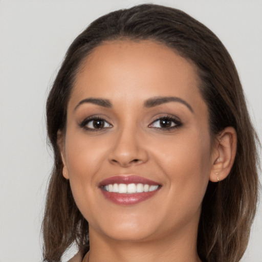 Joyful white young-adult female with long  brown hair and brown eyes