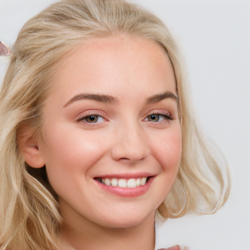 Joyful white young-adult female with long  brown hair and blue eyes