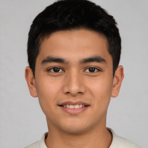 Joyful latino young-adult male with short  black hair and brown eyes