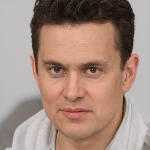 Joyful white adult male with short  brown hair and brown eyes