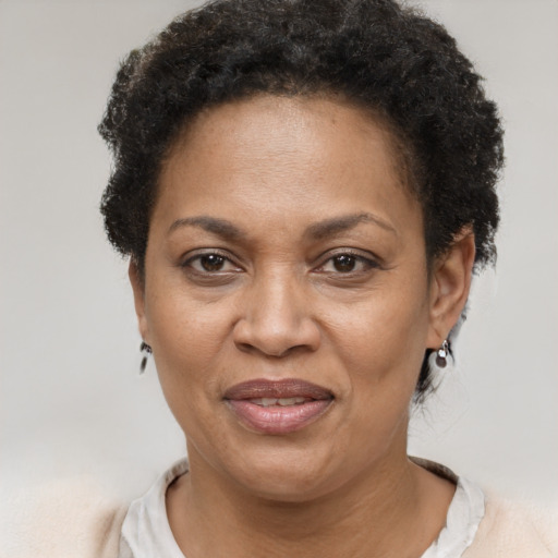 Joyful black adult female with short  brown hair and brown eyes