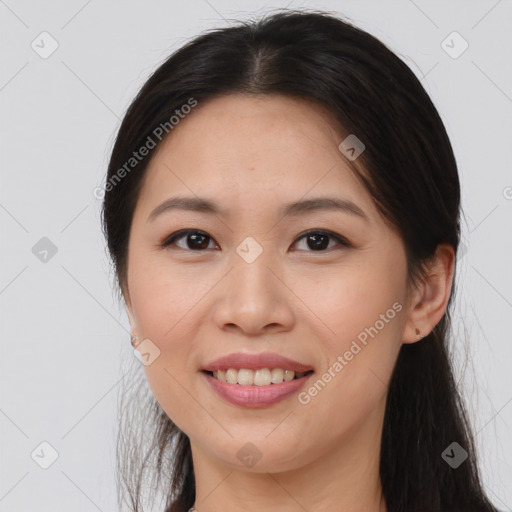 Joyful asian young-adult female with long  brown hair and brown eyes