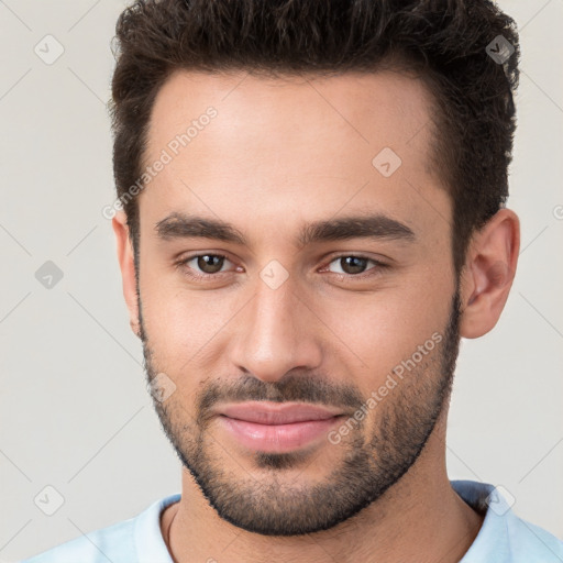 Joyful white young-adult male with short  brown hair and brown eyes