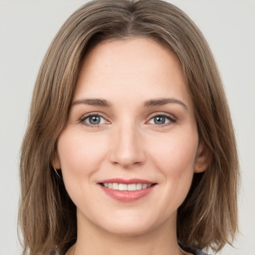 Joyful white young-adult female with long  brown hair and green eyes