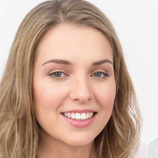 Joyful white young-adult female with long  brown hair and green eyes